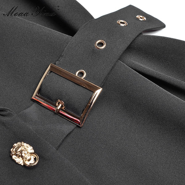 Belt buckle and gold decoration on black dress
